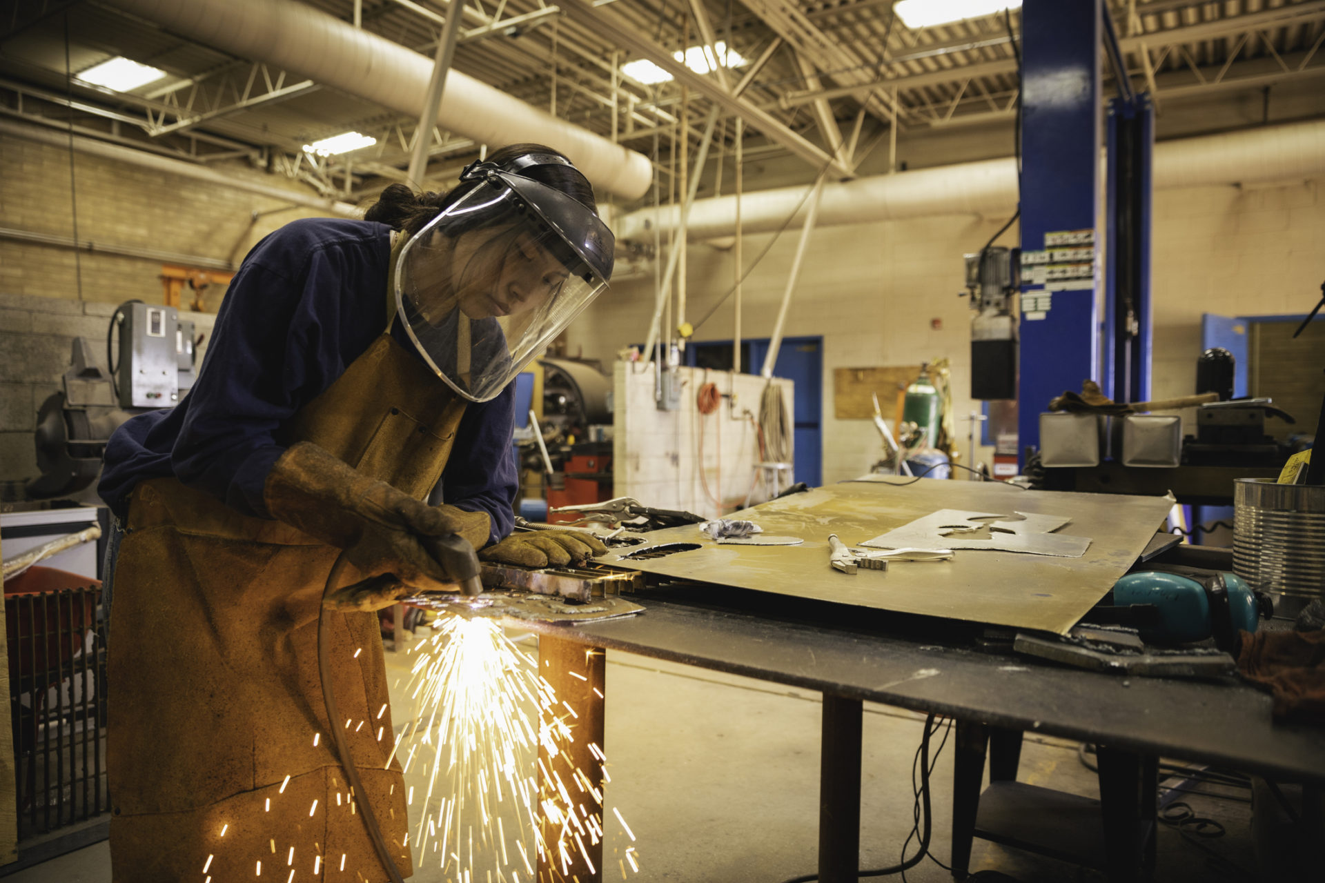 Young woman welding